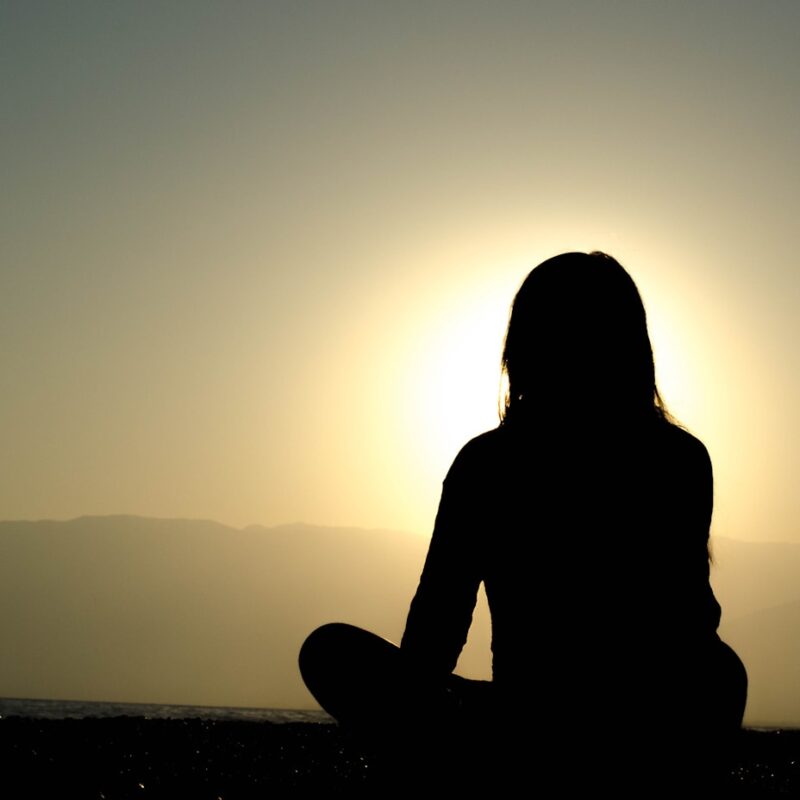 woman sitting on sand