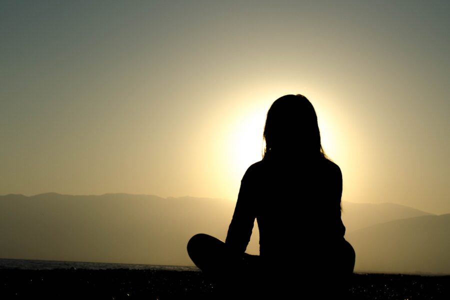 woman sitting on sand